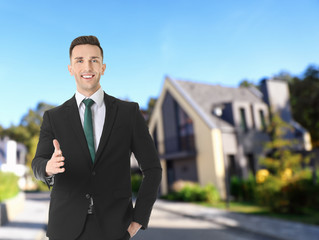 Real estate agent against modern house. Space for text