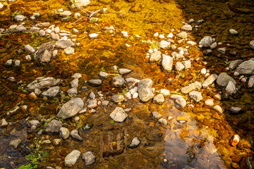 Brown water mirror with river stones