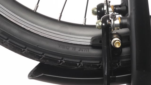 Closeup shots on the breaks of a bicycle stopping the wheel when pressed.