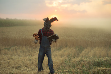 Man in image of sorcerer performs a voodoo ritual and holds doll impaled wire.