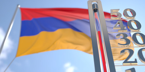 Thermometer shows high air temperature against blurred flag of Armenia. Hot weather forecast related 3D rendering