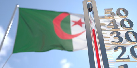 Thermometer shows high air temperature against blurred flag of Algeria. Hot weather forecast related 3D rendering