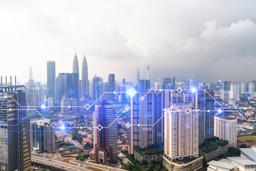 Technology hologram over panorama city view of Kuala Lumpur. KL is the largest tech hub in...