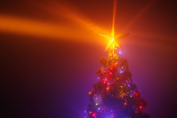 Christmas tree with festive lights, purple background with mist