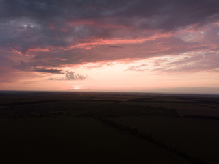Aerial view. Sunset over Ukrainian agricultural fields.