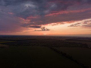 Aerial view. Sunset over Ukrainian agricultural fields.