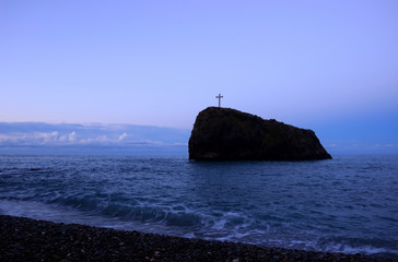 A rock with a cross protruding from the sea. Crimean peninsula.