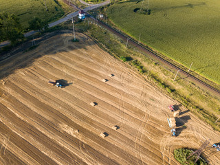 Obraz premium Aerial view. Harvesting wheat in the Ukrainian field.