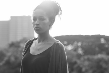 Portrait of young beautiful African woman at the park in black and white
