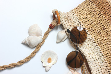 Sunglasses on Knitted woman bag with accessories for vacation in summer.