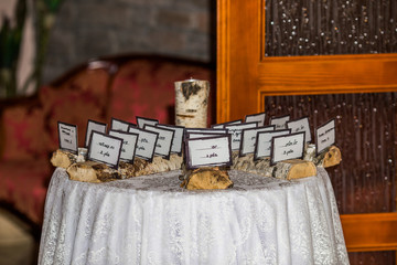 A fragment of decor at a wedding, a table with cards for seating at a Jewish wedding.