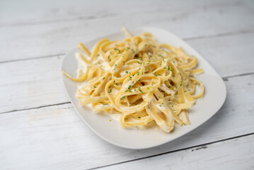 Alfredo pasta dinner with creamy white sauce and herbs