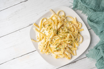 Alfredo pasta dinner with creamy white sauce and herbs