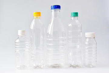 Five clear plastic bottles on a white background. Ecology.