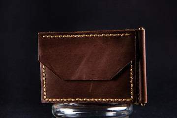 leather wallets on a black background with space for an inscription. Leather craft concept.