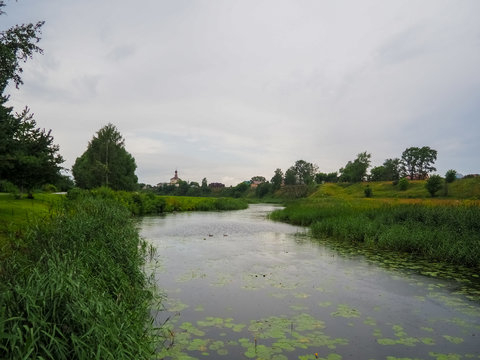 photo of a large field and a wide river in Suzdal in cloudy weather