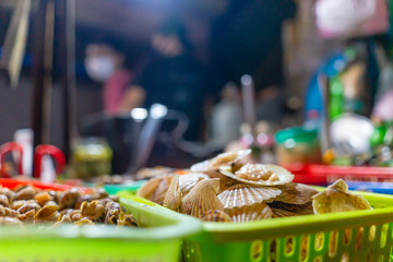 Seafood on the counter and Snail's for sale in a night market in Ho Chi Minh city (Saigon), Vietnam.