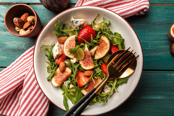 vegetarian salad with rucola, figs, blue cheese, strawberries, grapes