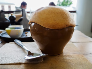 photo roast beef and venison in a clay pot covered with a layer of dough
