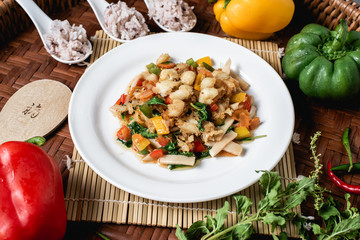 Crab meat fried bell pepper on the wooden background.