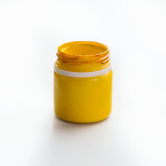 A can of paint on a white isolated background. Yellow paint in a can. Gouache and acrylic.