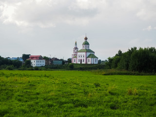 photo of a wide Russian field with white stone Orthodox churches