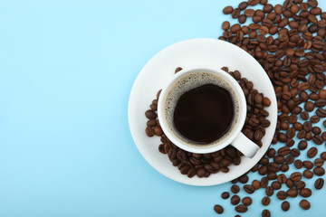 coffee beans and coffee cup on colored background with place for text
