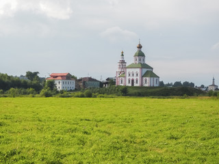 photo of a wide Russian field with white stone Orthodox churches