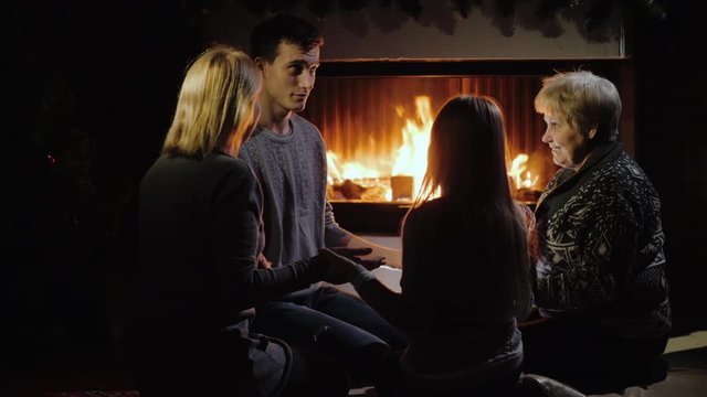 Cheerful family plays by the fireplace, have a good time together