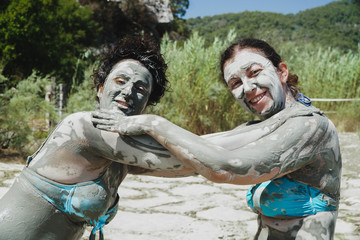 Fototapeta na wymiar two woman having a mud bath.