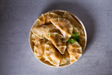 Dumplings, filled with cabbage. Varenyky, vareniki, pierogi, pyrohy - dumplings with filling. View from above, top studio shot