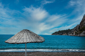 Canopy and deck chair on beach by sea