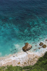 Top View of Suwehan beach on Nusa Penida Island, Bali, Indonesia. Amazing  view, green plants, white sand beach with rocky mountains and azure lagoon with clear water of Indian Ocean 