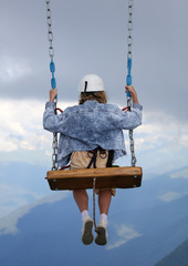 The girl took off on a swing into the clouds.