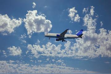 Airplane in the clouds is ready for landing at the airport