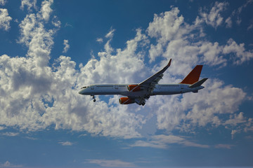 Airplane in the clouds is ready for landing at the airport