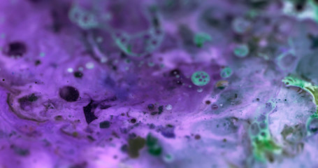 Macro Paint with Vibrant Color Palette. Oil Mixed with Bright Purple and Deep Green Dye and Paint.