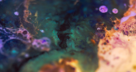 Macro Paint with Vibrant Color Palette. Oil Mixed with Bright Orange and Purple and Deep Green Dye and Paint.