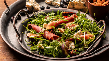 Prosciutto salad with figs and blue cheese. Food for wine