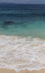 Suwehan beach on Nusa Penida Island, Bali, Indonesia. Amazing  view, white sand beach with rocky mountains and azure lagoon with clear water of Indian Ocean 