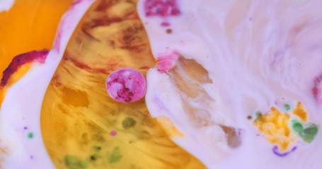 Macro Paint with Vibrant Color Palette. Oil Mixed with Bright Orange and Pink Dye and Paint.
