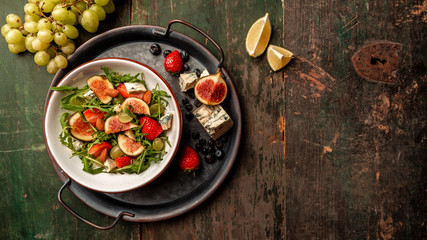 vegetarian salad with figs, strawberries, grapes, blue cheese dorblu. Long banner format, top view