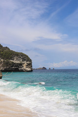 Suwehan beach on Nusa Penida Island, Bali, Indonesia. Amazing  view, white sand beach with rocky mountains and azure lagoon with clear water of Indian Ocean 