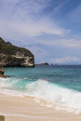 Suwehan beach on Nusa Penida Island, Bali, Indonesia. Amazing  view, white sand beach with rocky mountains and azure lagoon with clear water of Indian Ocean 