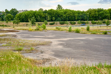 Fototapeta na wymiar Huge abandoned parking lot near the highway 