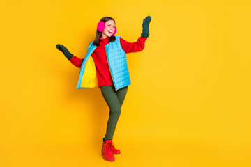 Full length photo of positive cheerful girl enjoy winter holiday weekend dance discotheque raise hands wear blue pink jumper isolated over bright shine color background