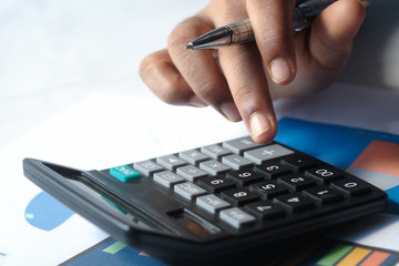 Close up of man hand using calculator 
