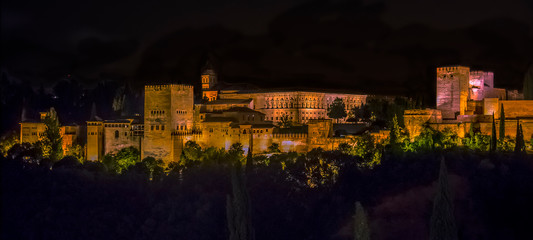 A view from Saint Nicholas Square, Granada, Spain towards the central part of the Alhambra district at night in the summertime