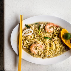 Flat lay food photography: Authentic Singapore Hokkien prawn mee served in a local food court. 