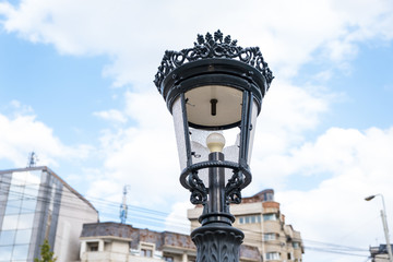 Fototapeta na wymiar Old metal lantern from the broken city. Selective focus 